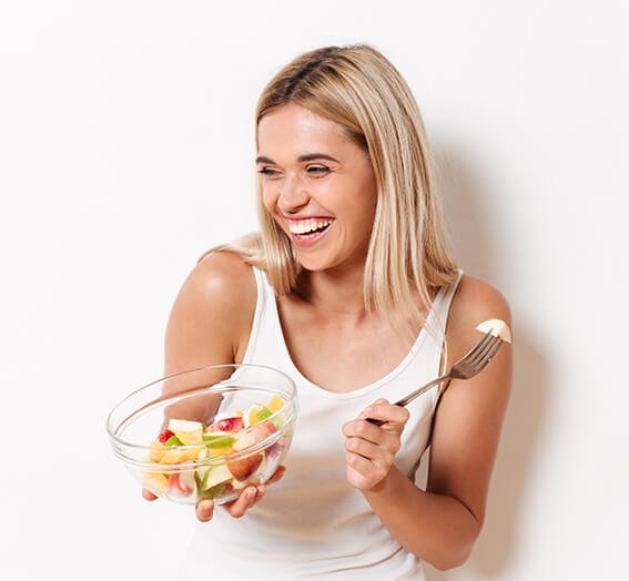 Portrait of a happy smiling girl in underwear holding