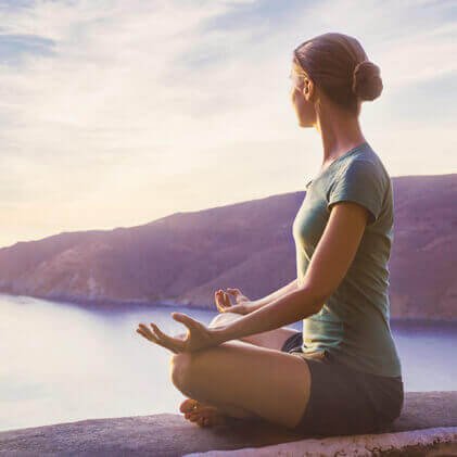 woman-meditating-on-mountain