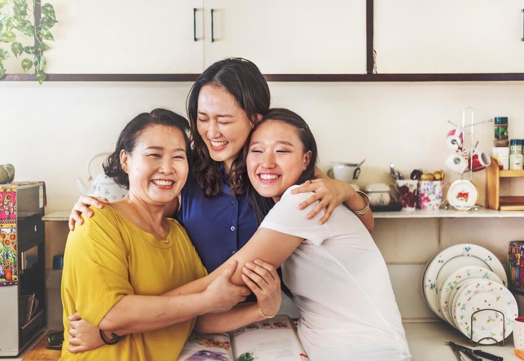 Happy mother and daugthers hugging their mother in a house kitchen meditation videos 3