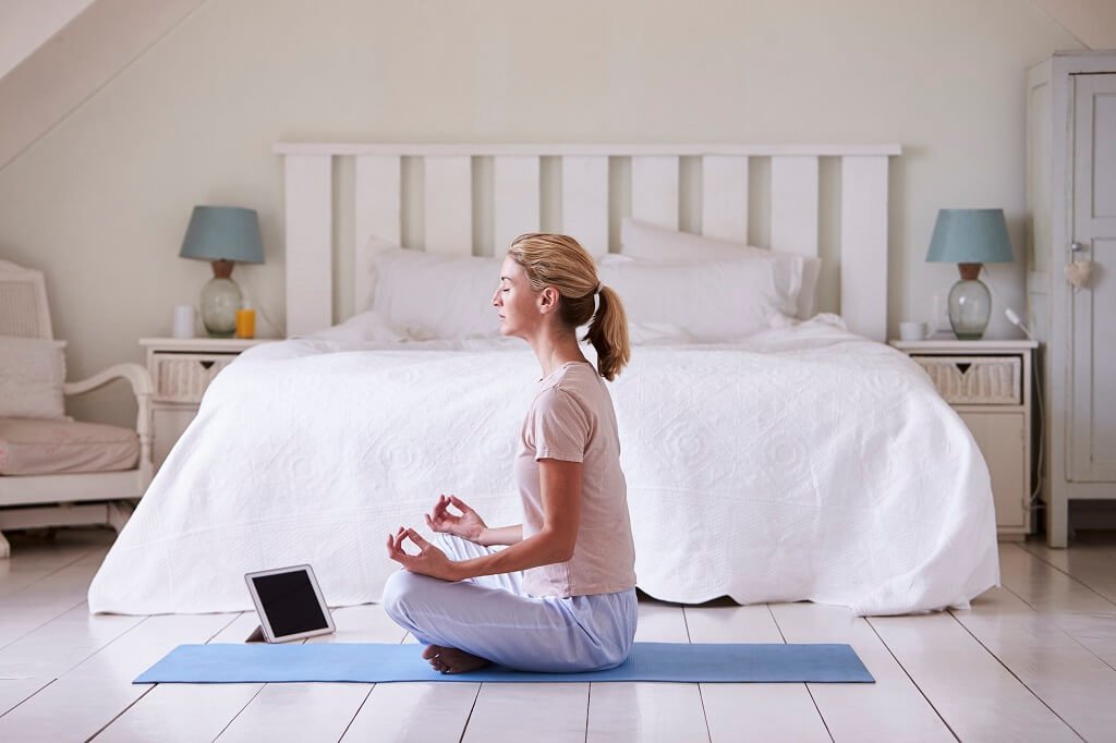 Woman With Digital Tablet Using Meditation App In Bedroom morning meditation