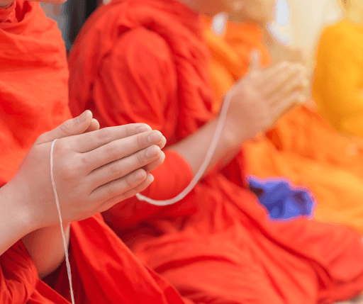 Monks chanting to seek protection with their hands closed