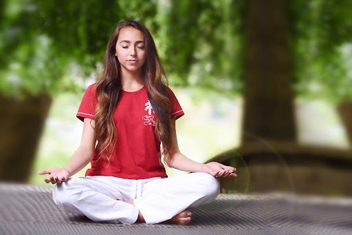 a meditating girl looking for stress relief retreat