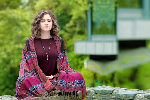 a woman practicing meditation for sleep problems
