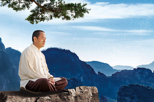 Grandmaster JinBodhi practicing Buddhist meditation for beginners on a rock.