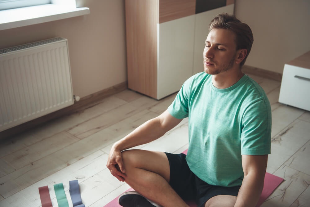 A young man picking up meditation techniques for beginners.