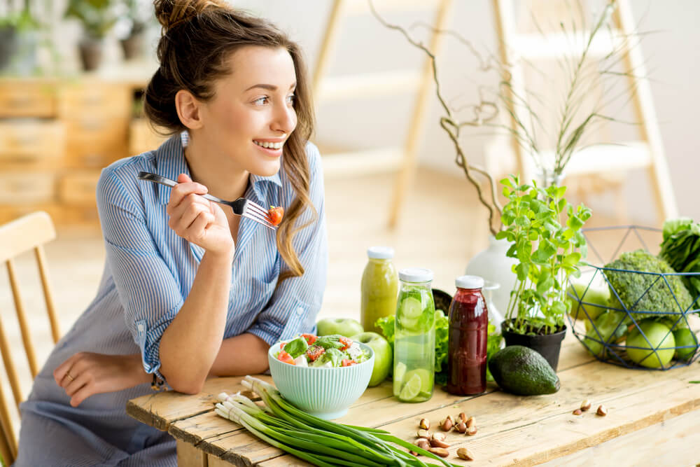 A young lady keeping a healthy diet and the habit of meditation for weight loss.