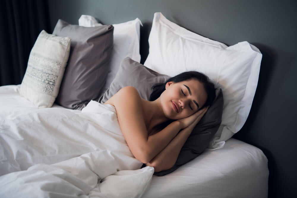 A woman sleeping better after practicing meditation for sleep problems.