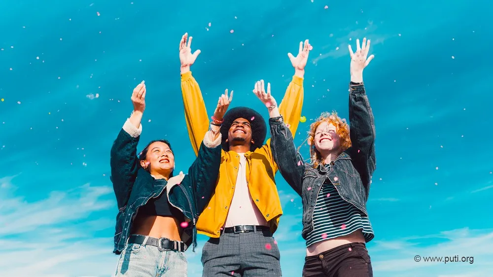 Happy people reaching for the sky.