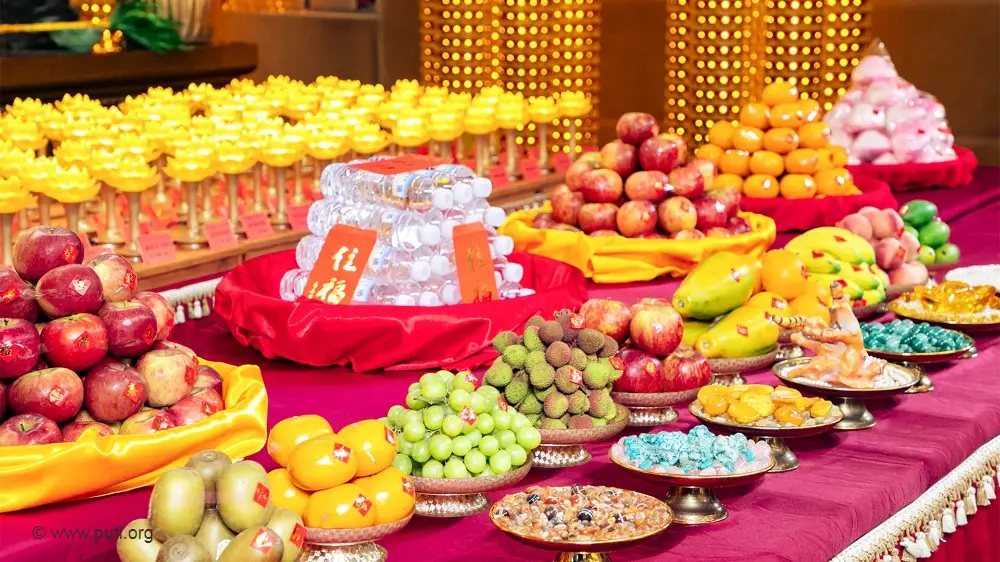 Offerings of food and light to the Buddha.