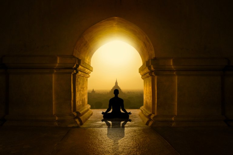 Image of man meditating in a temple