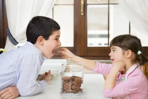 Image of two kids sharing food