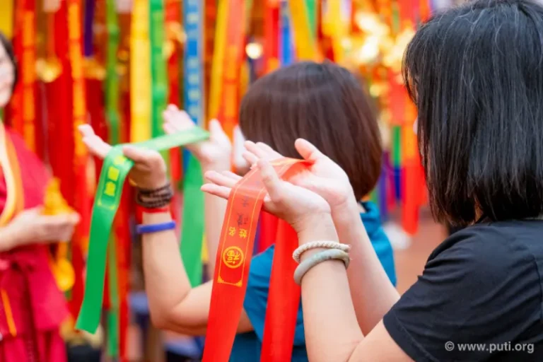 Hanging wishes on the Wishing Wall