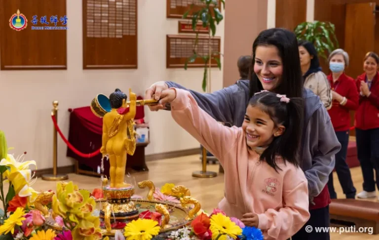 Families bathing the Buddha with smiles and devotion