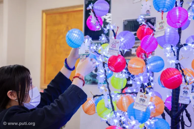 Participants hanging colorful lanterns with wishes