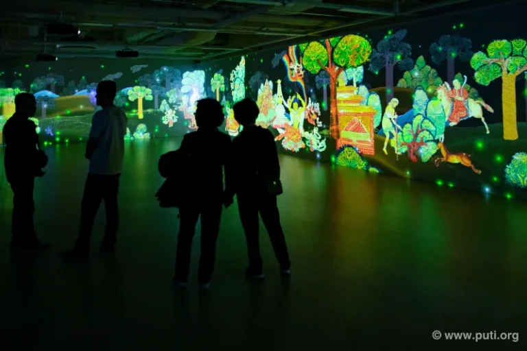 Audiences in awe at the 3D Buddhist light show, immersed in the beauty and mystery of the Dharma