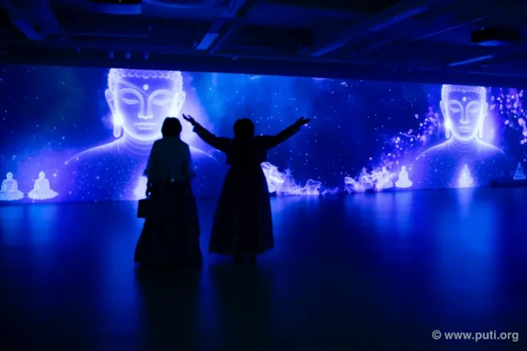 Audiences in awe at the 3D Buddhist light show, immersed in the beauty and mystery of the Dharma