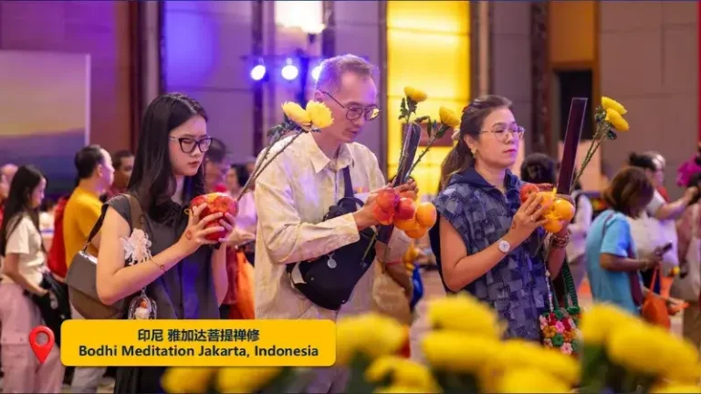 Devotees in the Jakarta Bodhi Meditation Center offer flowers before the Buddha.